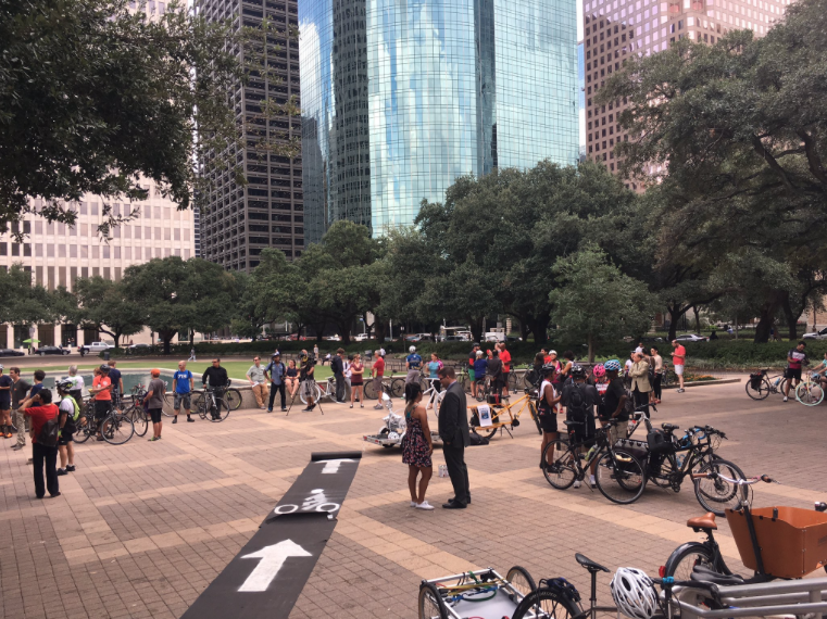 City Hall plaza with people, bicycles, and a temporary bike lane rolled out across the plaza.